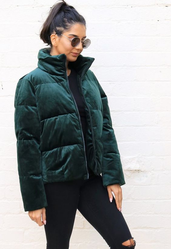 a total black look accented with a forest green velvet puffer jacket for a trendy feel