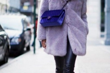 a total black look is spruced up with a lavender short faux fur coat and a bright purple crossbody bag