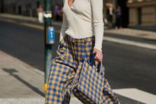 a whimsy and bright outfit with a neutral top, colorful plaid wideleg pants and a matching bag for the fall