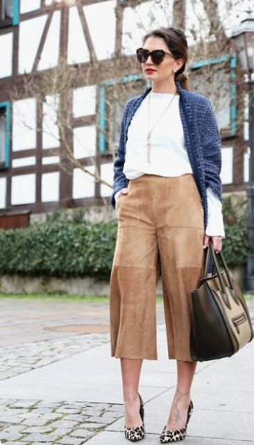 a white long sleeve jumper, a navy oversized cardigan, tan leather culottes, animal print shoes and a black bag