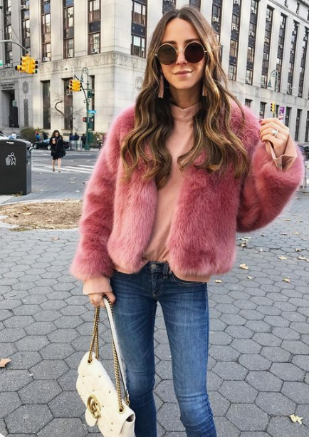 an everyday look spruced up with a bright short pink faux fur coat and a white bag is amazing