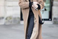 02 a black hoodie and jeans, a tan midi coat and tan hiking boots, a black bag for a sporty look
