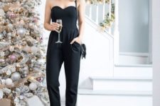 15 a strapless black jumpsuit with pockets and black heels, a black bag and a statement necklace for NYE