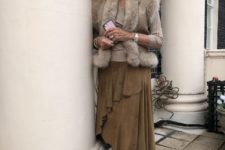 With beige sweater, fur vest, ruffled midi skirt and high boots