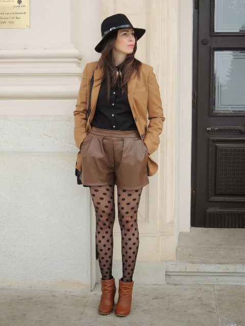 With black button down shirt, brown blazer, brown leather shorts, hat, bag and brown ankle boots