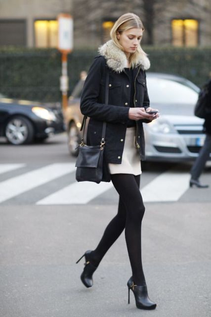 With black fur collar jacket, black bag and high heeled boots