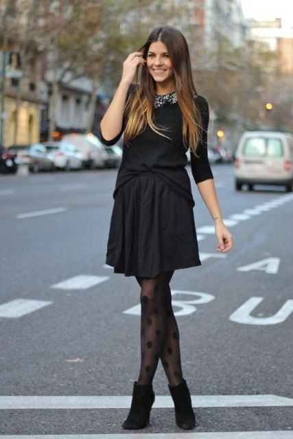With black mini dress and black suede ankle boots