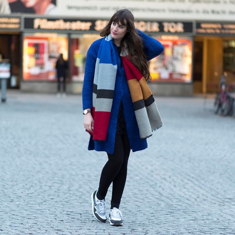 With blue coat, black leggings and sneakers