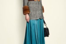 With blue pleated midi skirt, brown belt, black bag and red boots