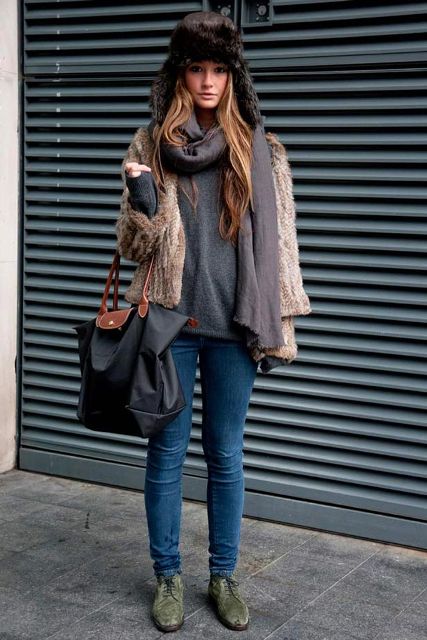 With gray sweatshirt, skinny jeans, green lace up flat boots, fur jacket and tote bag