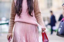 With pale pink pleated midi skirt and small bag