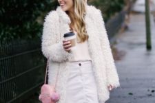 With pale pink shirt, faux fur coat, pink bag and pink boots