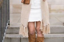 With sweater, oversized fringe scarf, brown leather clutch and brown suede high boots