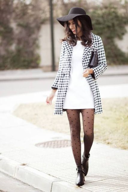 With white mini dress, printed coat, black wide brim hat, black clutch and boots