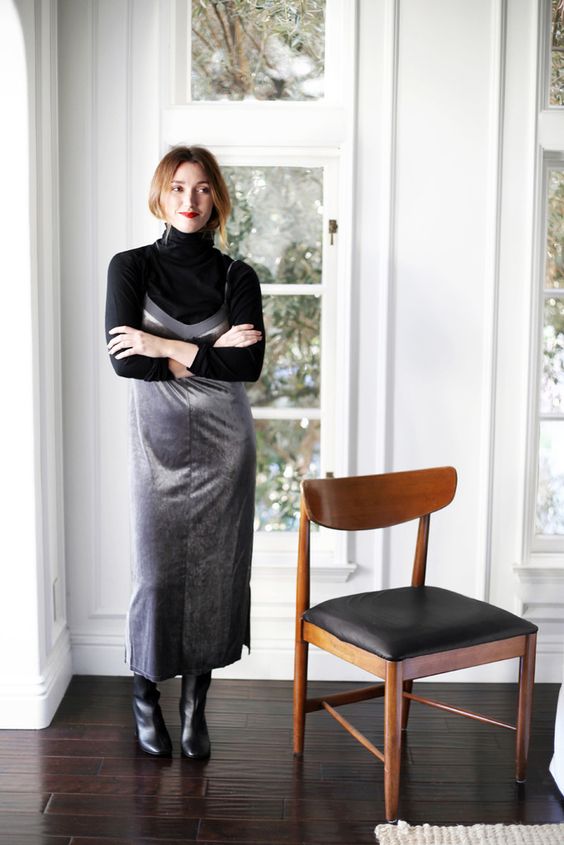 a black turtleneck, a silver slip dress, black tall boots for a monochromatic and shiny look