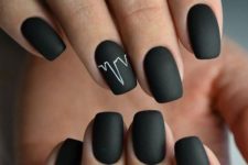 a matte black manicure with a signel heartbeat accent in white is a stylish and modern idea to try