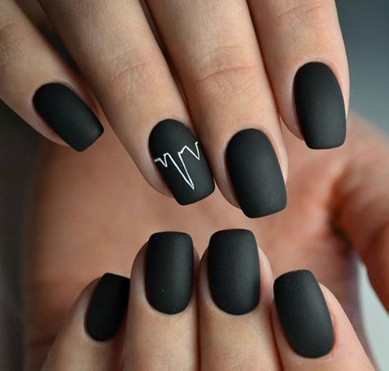 a matte black manicure with a signel heartbeat accent in white is a stylish and modern idea to try