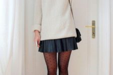 a simple look with a neutral sweater, a black pleated mini, printed tights and black booties