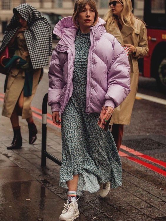 a simple look with a printed grey maxi dress, white trainers and an oversized pink padded coat