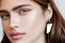 a statement single earring with some hoops and a chain with a bead is a modern idea