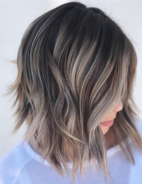 a torn bob haircut with slight waves and a mushroom blond balayage to make your look edgy
