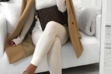 a white knit suit with pants and a turtleneck, a camel coat and matching trainers for a neutral winter look