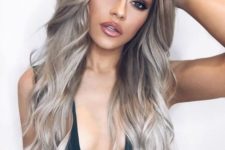 long wavy mushroom blond hair with a darker top and lighter ends for a sexy and chic look
