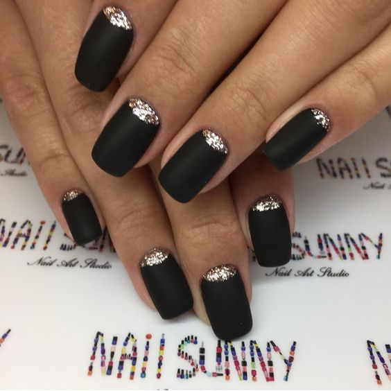 matte black nails with gold glitter half moon accents that make them really stand out and look wow