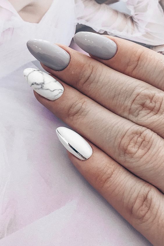 shiny grey nails paired with a marble and a white nail with a metallic stripe for a modern girl