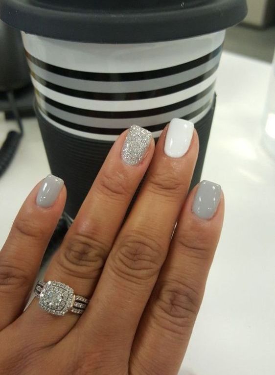 shiny grey nails paired with a white and a silver glitter one look holiday-like and very cute
