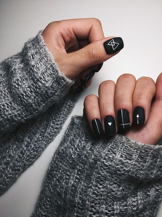 stylish matte black nails with boho white designs are great for a modern girl who loves all things boho