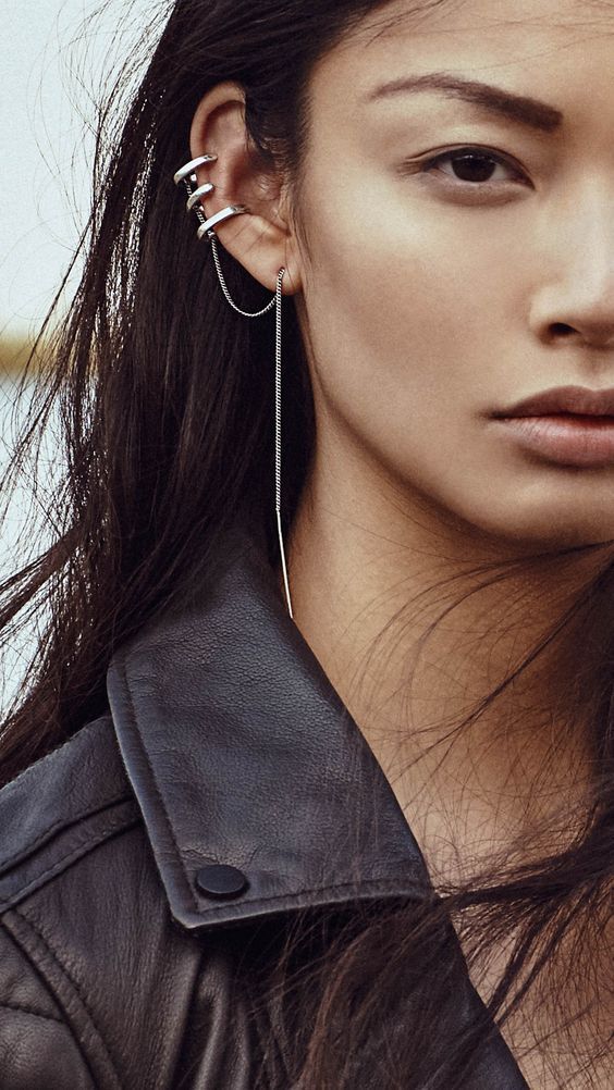 bulky silver geometric ear cuffs with an additional chain will make your look stand out a lot