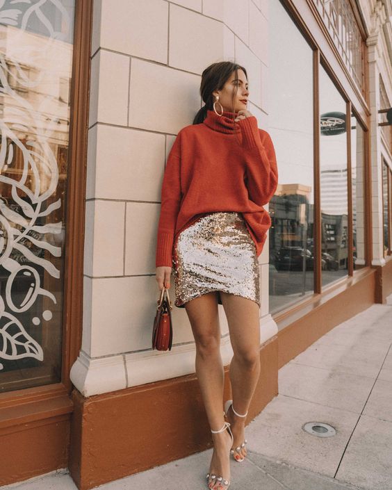 an oversized rust sweater, a silver sequin mini, silver ankle strap shoes and a bold bag plus statement earrings