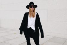 05 a relaxed monochromatic look with a white tee, black jeans, black chunky boots, a black short coat and a hat