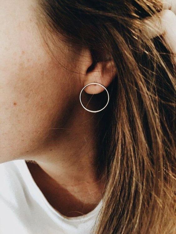 a non-traditional minimalist hoop earring that is placed in your ear in a different way