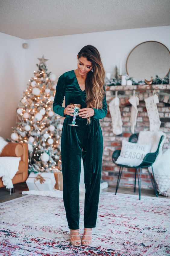 a teal velvet jumpsuit with a V-neckline and long sleeves is a chic and stylish outfit to go for these holidays