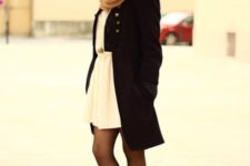 With beige dress, black coat and scarf