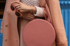 With beige sweater, coat and pale pink skirt