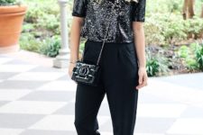 With black high-waisted pants, chain strap bag and silver shoes