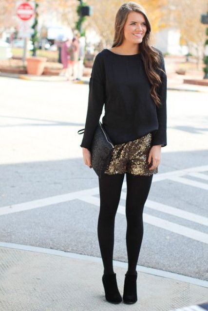 With black loose shirt, black clutch, black tights and black ankle boots