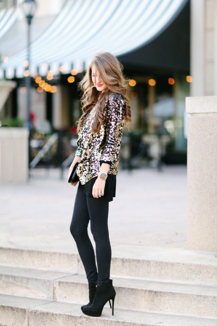 With black shorts, clutch, black tights and ankle boots
