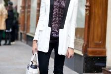 With black trousers, lace up shoes, white bag and white and black long blazer
