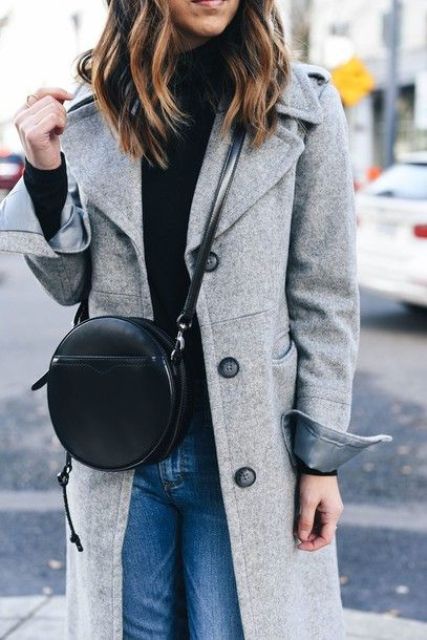 With black turtleneck, jeans and gray coat
