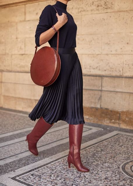 With blouse, pleated midi skirt and brown high boots