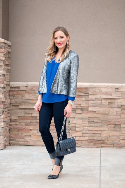 With blue blouse, cuffed jeans, chain strap bag and pumps