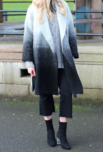 With gray sweater, black culottes and suede ankle boots