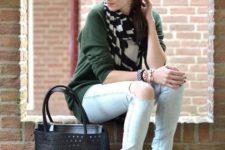 With green shirt, distressed jeans, black tote bag and lace up boots