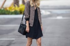 With mini dress, lace up flat shoes and black bag