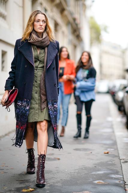 With olive green dress, navy blue coat, brown scarf and clutch