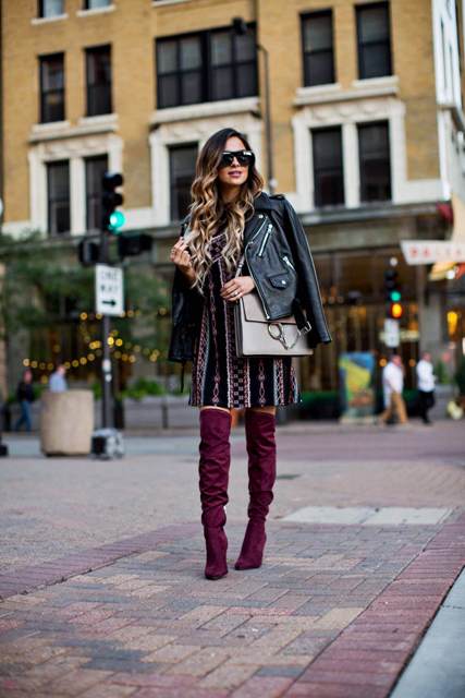 With printed mini dress, gray bag and black leather jacket